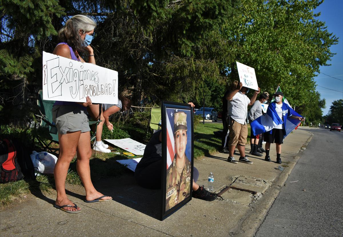 A small group of people, including Lupita Romo, countered Arnold's display with signs in Spanish and a large portrait of Vanessa Guillén, a soldier killed in Texas. (Justin Hicks/IPB News)