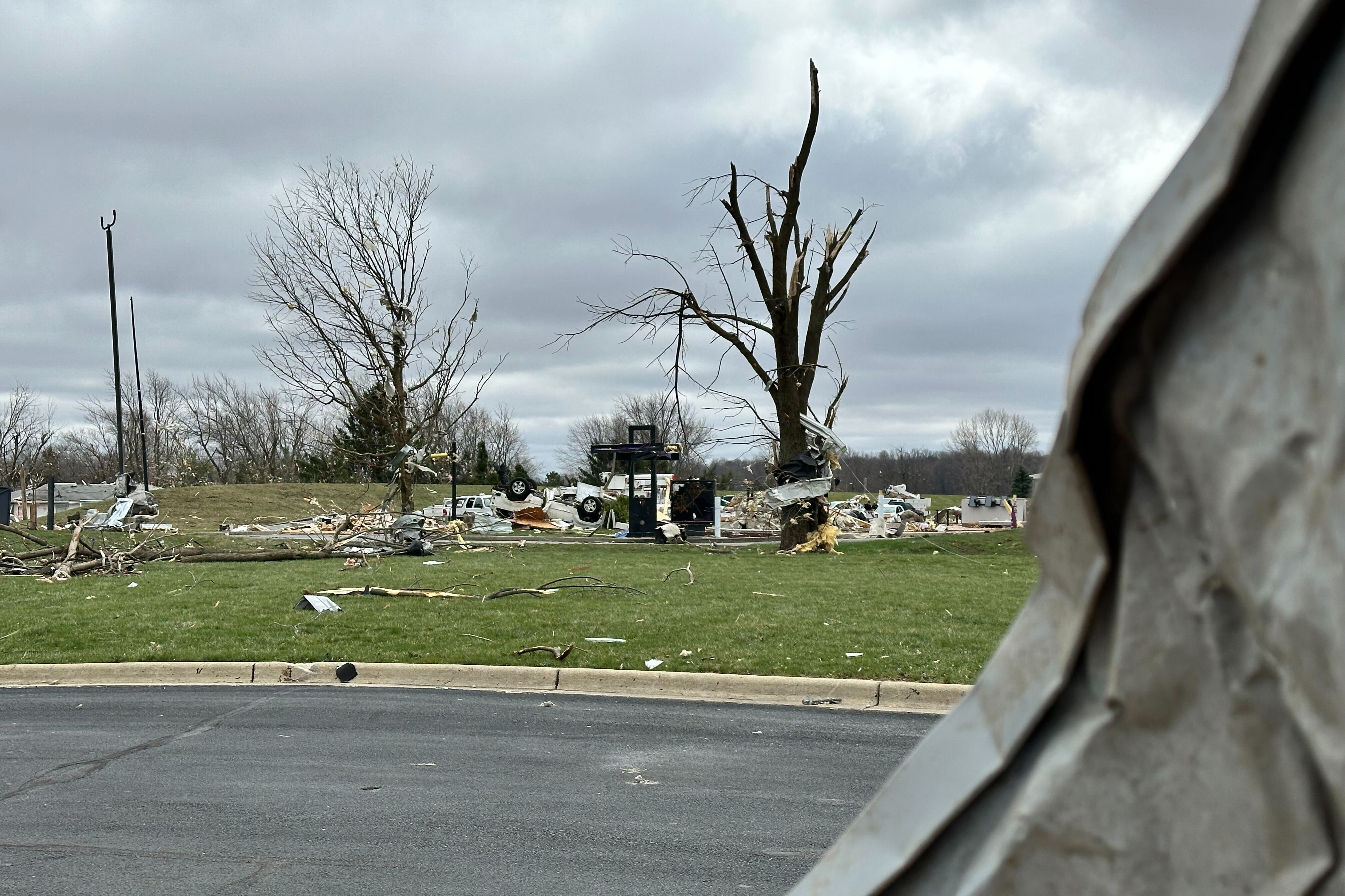 An empty lot with debris and a flipped over vehicle is all that is left of a Taco Bell in Winchester.